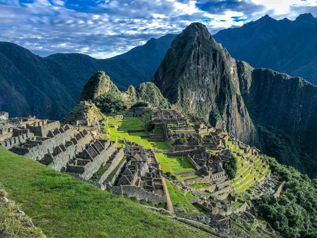 A breathtaking panoramic vista of Machu Picchu, the iconic Inca citadel perched atop a verdant Andean ridge. In the foreground, terraced stone ruins cast long shadows under a warm, golden light, evoking the grandeur of a bygone era. The middle ground features lush, layered peaks shrouded in wispy clouds, while the distant horizon is dominated by the majestic snow-capped Andes mountains. The scene exudes a serene, timeless atmosphere, perfectly capturing the essence of the best time to visit this wonder of the world, when crowds are sparse and the views are crystal clear. A breathtaking panoramic vista of Machu Picchu, the iconic Inca citadel perched atop a verdant Andean ridge. In the foreground, terraced stone ruins cast long shadows under a warm, golden light, evoking the grandeur of a bygone era. The middle ground features lush, layered peaks shrouded in wispy clouds, while the distant horizon is dominated by the majestic snow-capped Andes mountains. The scene exudes a serene, timeless atmosphere, perfectly capturing the essence of the best time to visit this wonder of the world, when crowds are sparse and the views are crystal clear.