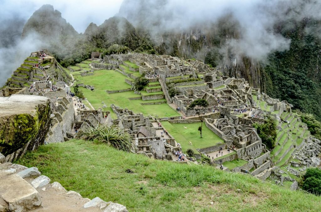 A breathtaking panoramic vista of the Andean Highlands, showcasing the iconic Inca ruins of Machu Picchu nestled amidst towering peaks and verdant valleys. The ancient stone structures stand in reverent harmony with the surrounding natural splendor, bathed in warm, golden light that filters through wispy clouds. In the foreground, the winding Inca Trail snakes through rugged terrain, offering a glimpse of the arduous yet rewarding journey to this sacred site. The vibrant hues of the lush, terraced Sacred Valley and the historic city of Cusco create a captivating backdrop, evoking the timeless allure of this enchanting region. The overall composition conveys a sense of timeless wonder and the enduring legacy of the Inca civilization. A breathtaking panoramic vista of the Andean Highlands, showcasing the iconic Inca ruins of Machu Picchu nestled amidst towering peaks and verdant valleys. The ancient stone structures stand in reverent harmony with the surrounding natural splendor, bathed in warm, golden light that filters through wispy clouds. In the foreground, the winding Inca Trail snakes through rugged terrain, offering a glimpse of the arduous yet rewarding journey to this sacred site. The vibrant hues of the lush, terraced Sacred Valley and the historic city of Cusco create a captivating backdrop, evoking the timeless allure of this enchanting region. The overall composition conveys a sense of timeless wonder and the enduring legacy of the Inca civilization.