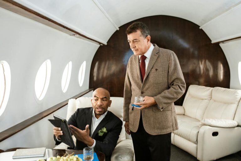 how much is it to rent a private jet, Two businessmen discussing plans inside a luxurious private jet.