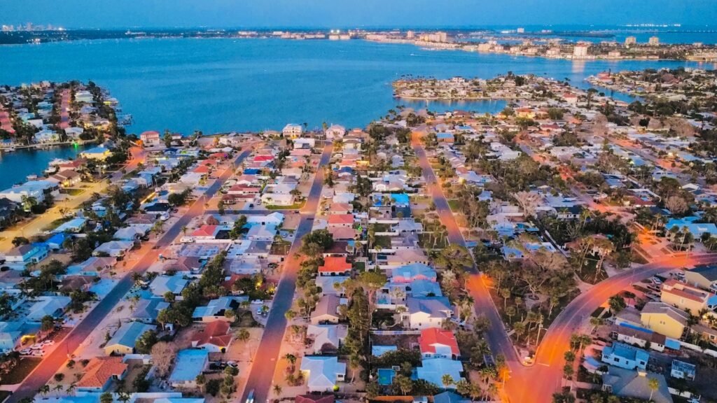 Aerial view of a waterfront neighborhood at dusk.