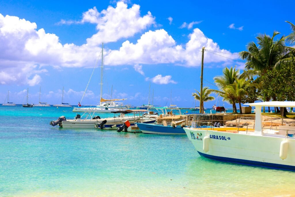 Boats are docked on a beautiful, sunny beach.