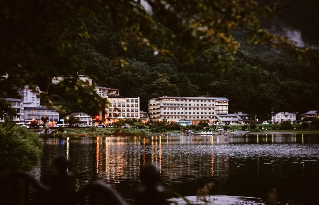 A panoramic, ultra-realistic photo of a picturesque mountain landscape in the Catskills, showcasing a diverse array of top-tier hotels and unique lodging options. In the foreground, a charming, rustic inn with a wrap-around porch and cozy fireplaces. In the middle ground, a modern, eco-friendly resort with sleek, glass-fronted suites and a tranquil, infinity-edge pool. In the background, a historic, grand hotel with ornate, Victorian-style architecture and lush, manicured gardens. The scene is bathed in warm, golden light, with dramatic shadows and highlights that accentuate the architectural details and natural beauty of the region. The overall atmosphere is one of relaxation, luxury, and endless possibilities for every style and budget. photo of a picturesque mountain landscape in the Catskills, showcasing a diverse array of top-tier hotels and unique lodging options. In the foreground, a charming, rustic inn with a wrap-around porch and cozy fireplaces. In the middle ground, a modern, eco-friendly resort with sleek, glass-fronted suites and a tranquil, infinity-edge pool. In the background, a historic, grand hotel with ornate, Victorian-style architecture and lush, manicured gardens. The scene is bathed in warm, golden light, with dramatic shadows and highlights that accentuate the architectural details and natural beauty of the region. The overall atmosphere is one of relaxation, luxury, and endless possibilities for every style and budget.