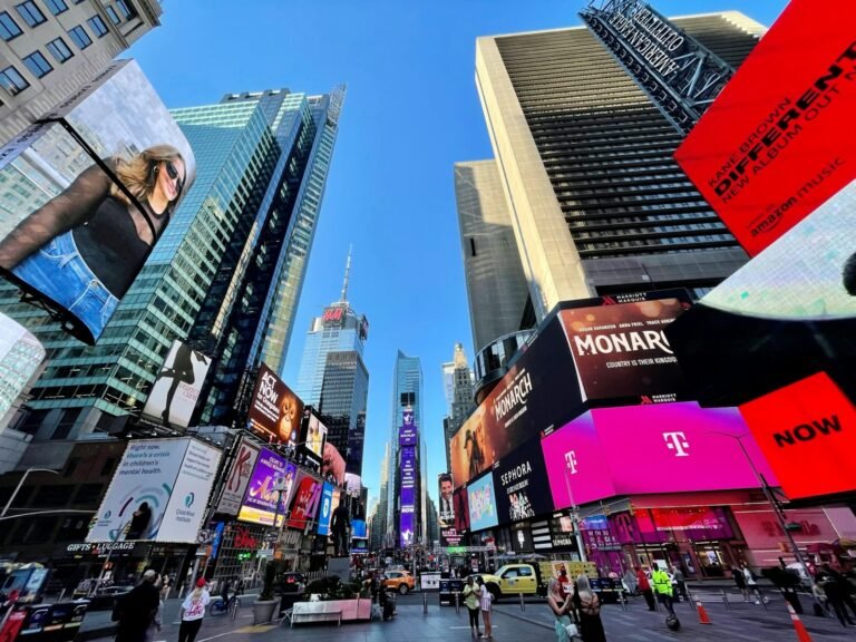 new york city street filled with lots of tall buildings