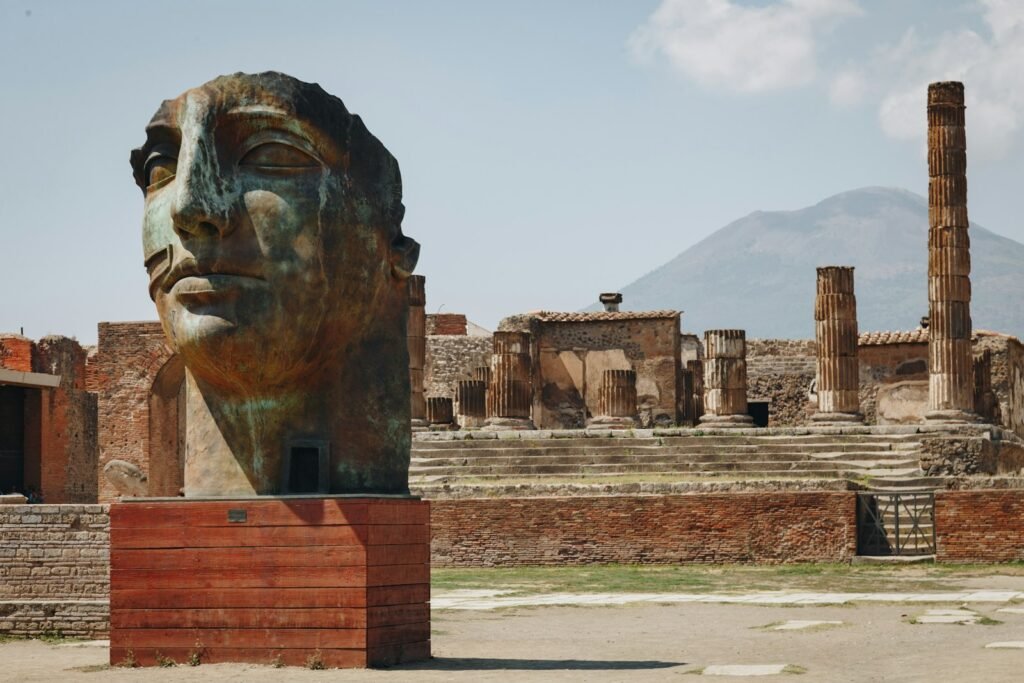 A bustling scene at the entrance to the ancient ruins of Pompeii, with a crowd of tourists eager to explore the historic site. In the foreground, a designated fast-track line snakes through the crowd, beckoning those with skip-the-line tickets or early access passes. The sun casts a warm glow over the scene, highlighting the ornate architecture of the entrance gates. In the middle ground, tour guides usher small groups through the priority lines, while the main queue stretches out behind them. In the background, the iconic Mount Vesuvius looms, a constant reminder of the city's tragic past. The overall atmosphere conveys a sense of excitement and anticipation, with visitors ready to immerse themselves in the wonders of Pompeii. A bustling scene at the entrance to the ancient ruins of Pompeii, with a crowd of tourists eager to explore the historic site. In the foreground, a designated fast-track line snakes through the crowd, beckoning those with skip-the-line tickets or early access passes. The sun casts a warm glow over the scene, highlighting the ornate architecture of the entrance gates. In the middle ground, tour guides usher small groups through the priority lines, while the main queue stretches out behind them. In the background, the iconic Mount Vesuvius looms, a constant reminder of the city's tragic past. The overall atmosphere conveys a sense of excitement and anticipation, with visitors ready to immerse themselves in the wonders of Pompeii.