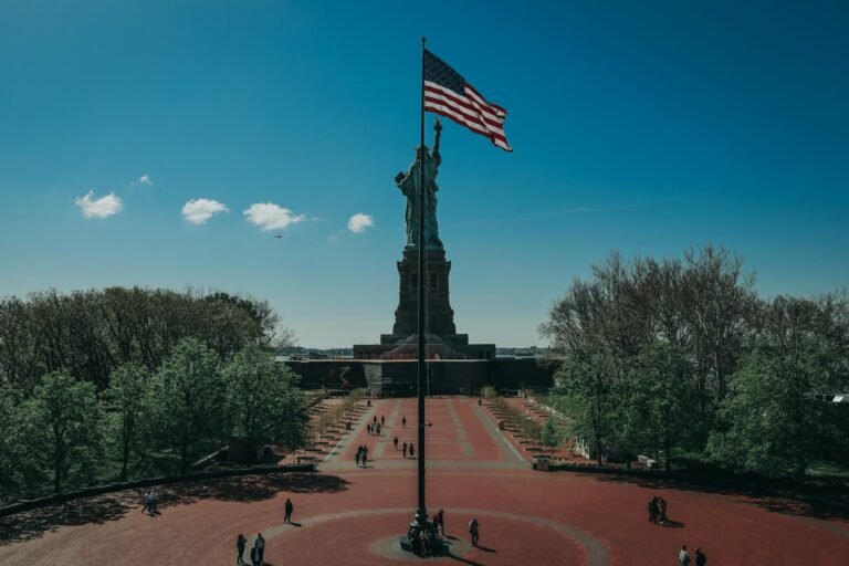 a flag on a flagpole with statue of liberty in day trips in ny