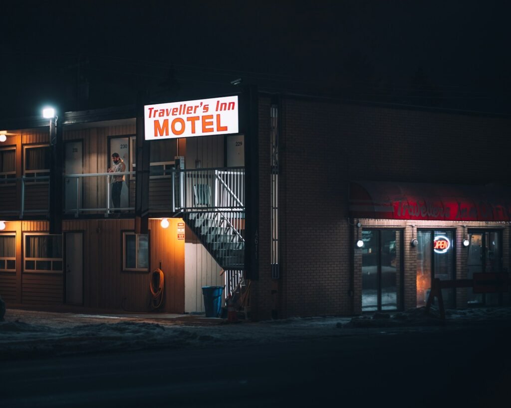 A cozy, value-focused motel nestled amid the vibrant cityscape of New York, its neon sign beckoning weary travelers. In the foreground, a well-worn yet charming entrance, inviting guests to step into an oasis of affordability. The middle ground reveals a bustling urban landscape, skyscrapers and yellow cabs creating a dynamic backdrop. Warm, diffused lighting casts a welcoming glow, while a wide-angle lens captures the sense of scale and opportunity that these value-driven accommodations offer. An ultra-realistic, immersive scene, showcasing the hidden gems of budget-friendly hospitality in the heart of the city that never sleeps. A cozy, value-focused motel nestled amid the vibrant cityscape of New York, its neon sign beckoning weary travelers. In the foreground, a well-worn yet charming entrance, inviting guests to step into an oasis of affordability. The middle ground reveals a bustling urban landscape, skyscrapers and yellow cabs creating a dynamic backdrop. Warm, diffused lighting casts a welcoming glow, while a wide-angle lens captures the sense of scale and opportunity that these value-driven accommodations offer. An ultra-realistic, immersive scene, showcasing the hidden gems of budget-friendly hospitality in the heart of the city that never sleeps.