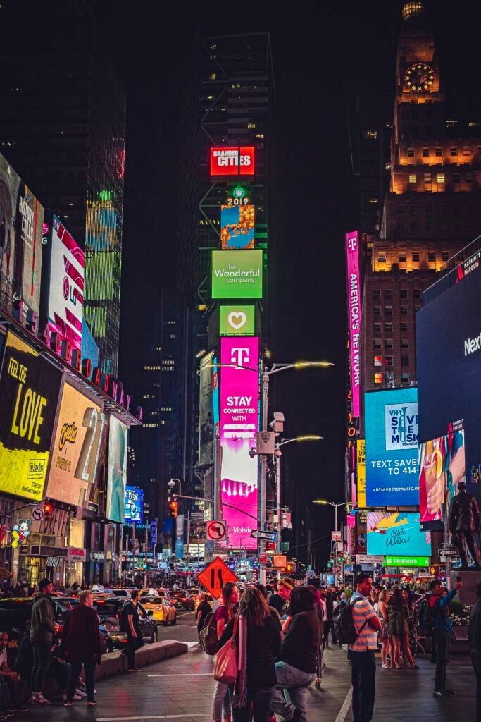 people walking on street during nighttime in new york city timesquare