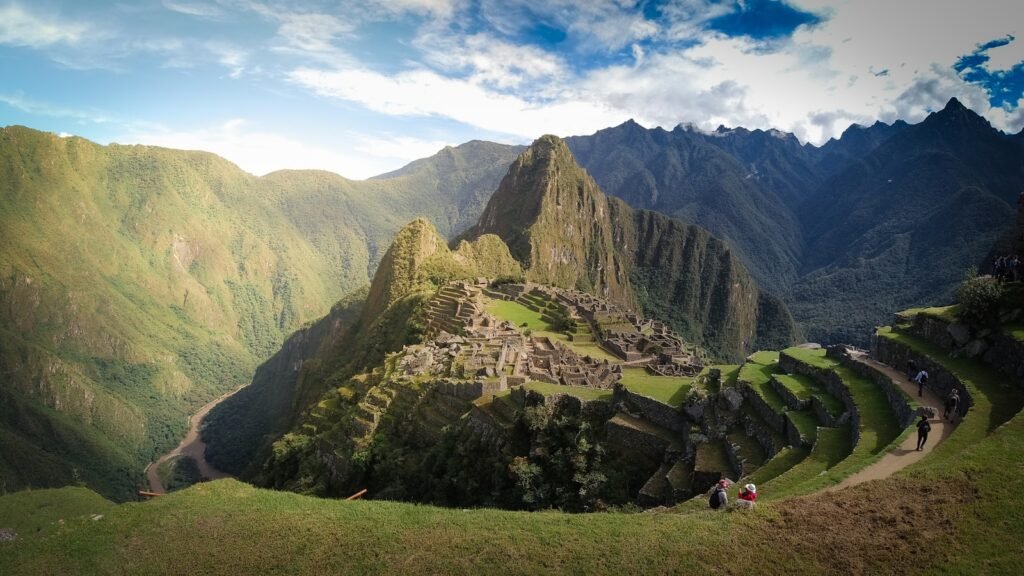 A lush, panoramic landscape showcasing the diverse travel experiences of South America. In the foreground, a group of adventurous backpackers explore a rugged mountain trail, their silhouettes contrasted against the vibrant flora. The middle ground reveals a luxurious hotel nestled among rolling hills, with guests indulging in spa treatments and fine dining. In the background, a bustling city skyline with iconic architecture and a colorful, lively street market, capturing the cultural richness of the region. Warm, golden lighting illuminates the scene, creating a sense of wonder and wanderlust. Captured with a wide-angle lens, the image conveys the breadth of South America's travel offerings, from outdoor adventures to urban sophistication.