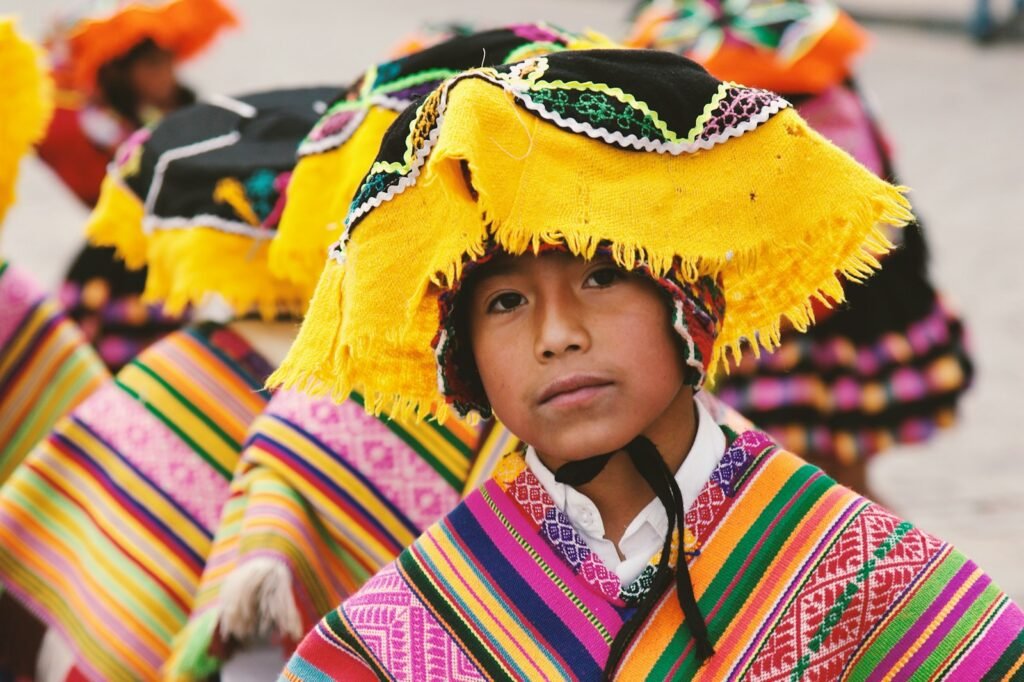 A boy in traditional costume in the heart of a South American city, bustling with activity and cultural authenticity. the background has a authentic cultural experiences on south american tours.