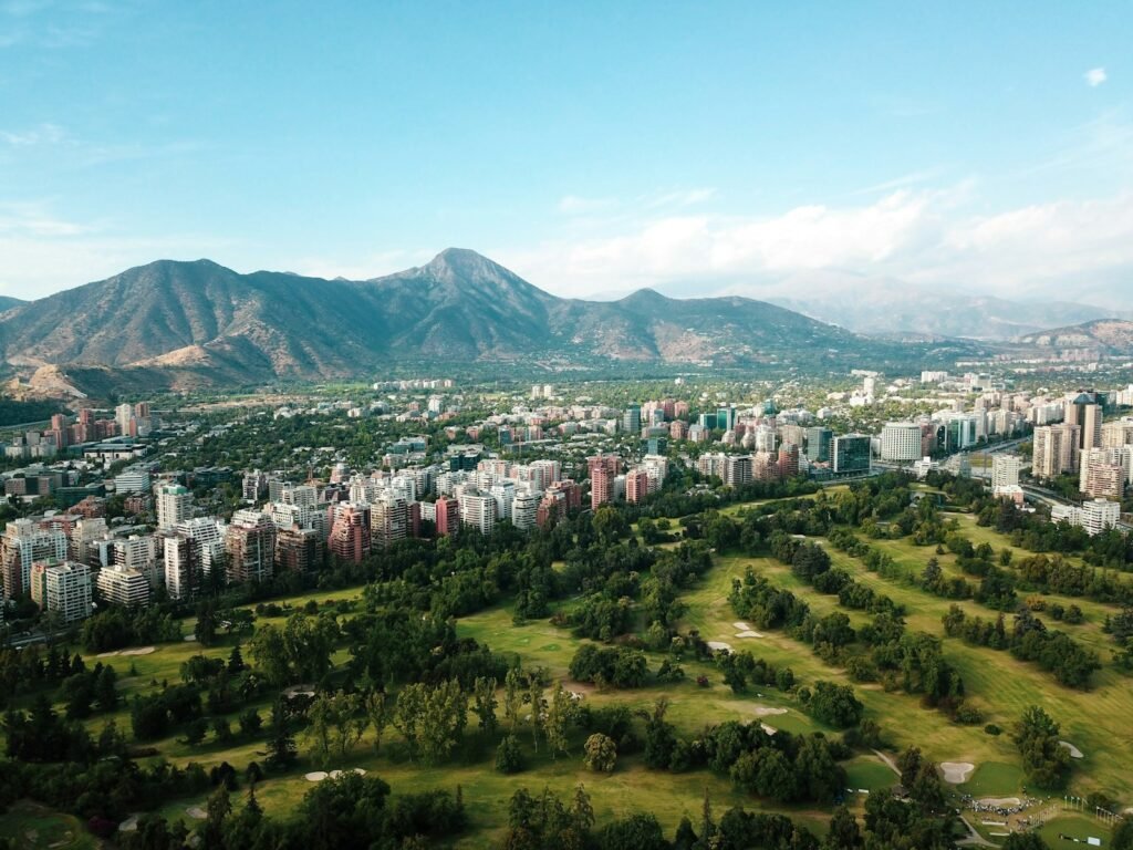 A serene landscape of lush tropical foliage, verdant mountains, and glistening azure waters. In the foreground, a group of people enjoying outdoor recreational activities - hiking, swimming, and relaxing on pristine beaches. The middle ground features vibrant local architecture, reflecting the rich cultural heritage of the region. The background showcases a picturesque skyline, bathed in warm, golden sunlight and a sense of tranquility. The scene conveys the safety, natural beauty, and authentic experience of visiting the safest Latin American countries. Captured with a wide-angle lens, the image portrays an inviting, secure, and captivating destination. A serene landscape of lush tropical foliage, verdant mountains, and glistening azure waters. In the foreground, a group of people enjoying outdoor recreational activities - hiking, swimming, and relaxing on pristine beaches. The middle ground features vibrant local architecture, reflecting the rich cultural heritage of the region. The background showcases a picturesque skyline, bathed in warm, golden sunlight and a sense of tranquility. The scene conveys the safety, natural beauty, and authentic experience of visiting the safest Latin American countries. Captured with a wide-angle lens, the image portrays an inviting, secure, and captivating destination.