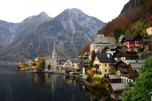 Charming European lakeside village surrounded by mountains, perfect for exploring Europe’s most scenic travel destinations.