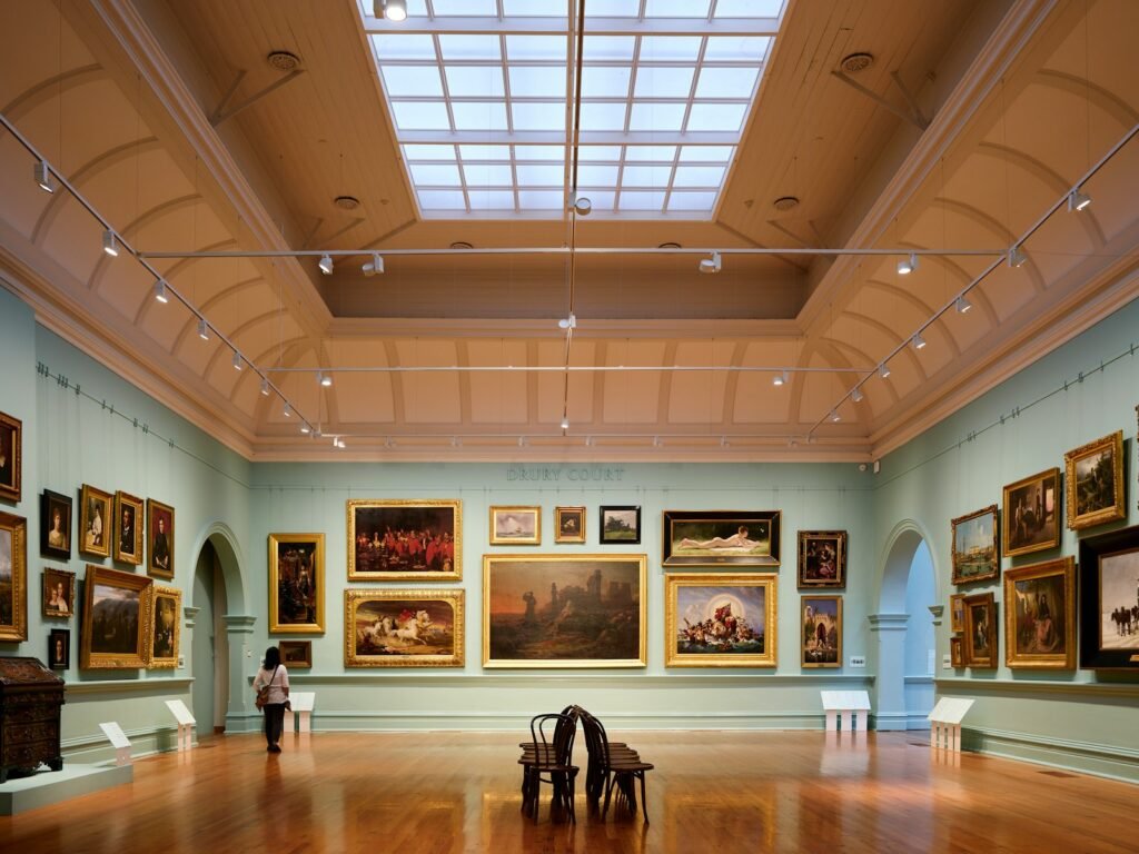 Interior of the American Folk Art Museum with paintings and a skylight — one of the cultural highlights among free things to do in NYC.