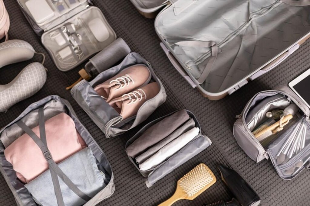 Packing cubes neatly organizing clothes, shoes, and travel essentials in an open suitcase — a must-have example showing why travelers ask, “Are packing cubes worth it?”