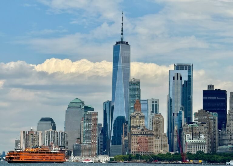 The Staten Island Ferry crossing New York Harbor with Manhattan skyscrapers in the background — one of the top free things to do in NYC.