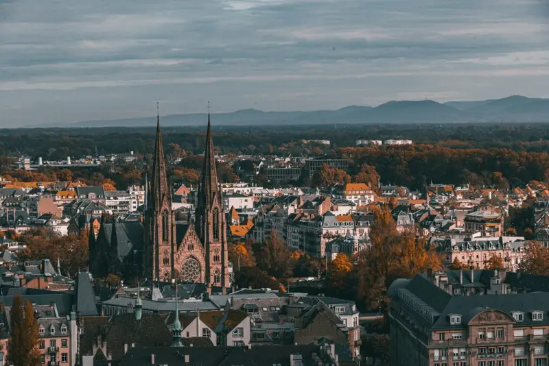 Exploring Europe: A Complete Guide to the Best Travel Experiences Panoramic view of a historic European city with cathedral spires and fall colors, showcasing the charm of Western Europe travel.
