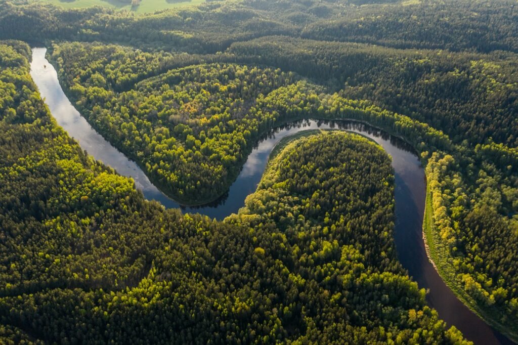 Aerial view of the winding Peru Amazon River cutting through lush rainforest, representing the adventure and beauty awaiting travelers planning their trip from the United States.