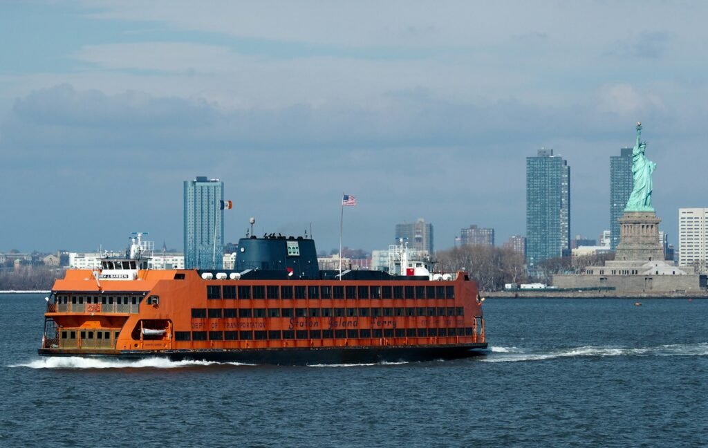 Close-up of the Staten Island Ferry sailing past the Statue of Liberty, a classic highlight among free things to do in NYC.